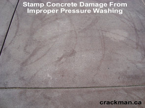 On this concrete driveway, notice the damage caused to the stamp concrete from incorrect use of a pressure washer.